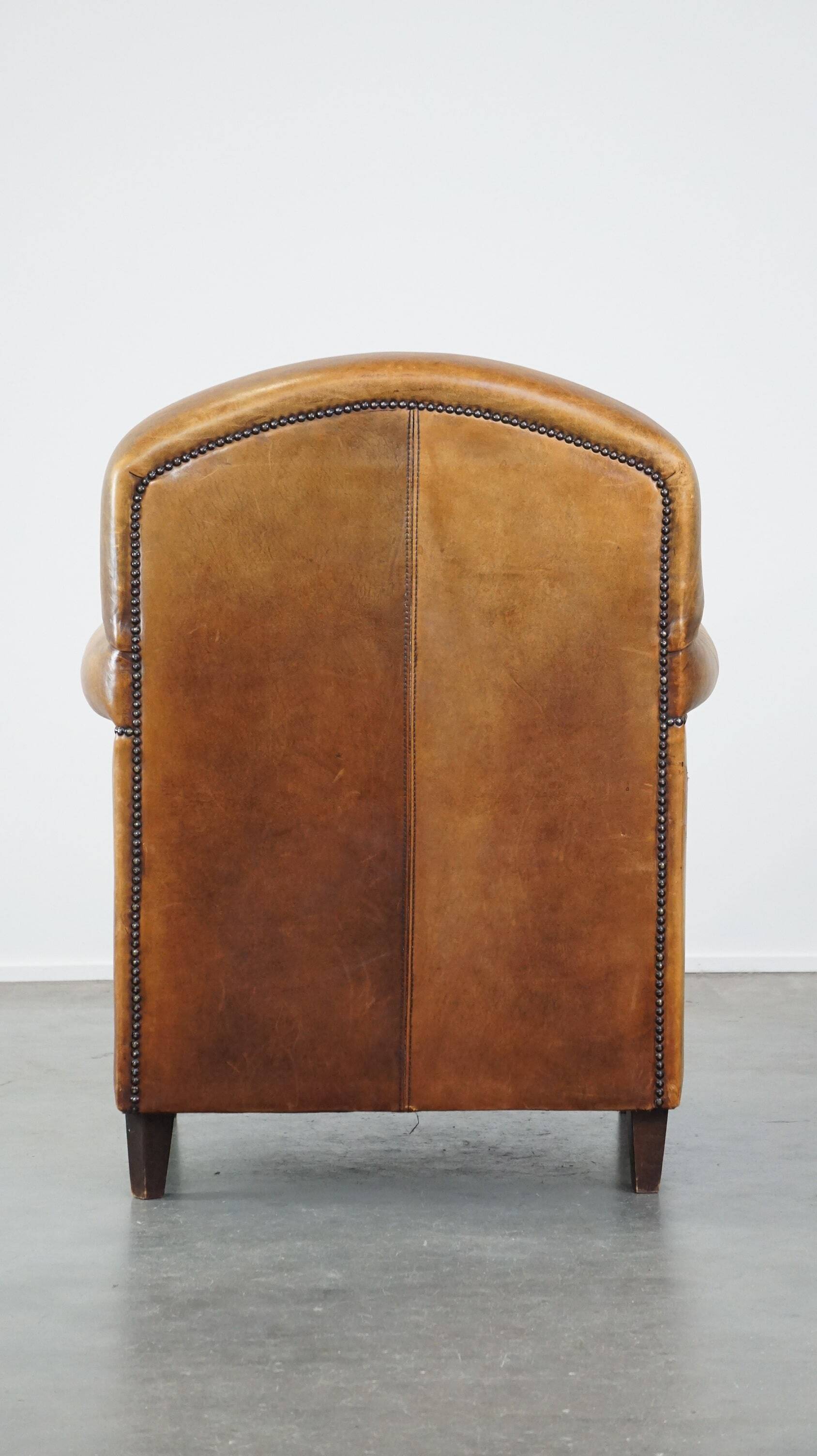 Stately, sleekly finished, comfortable sheepskin armchair