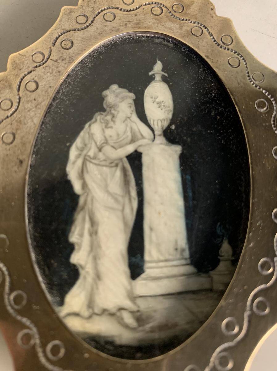 Miniature on ivory, oval brass frame.