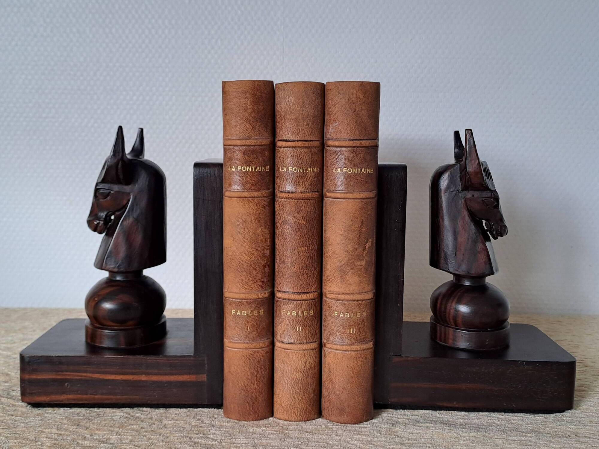 Pair of vintage wooden bookends with stylised horse heads.