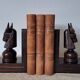 Pair of vintage wooden bookends with stylised horse heads.