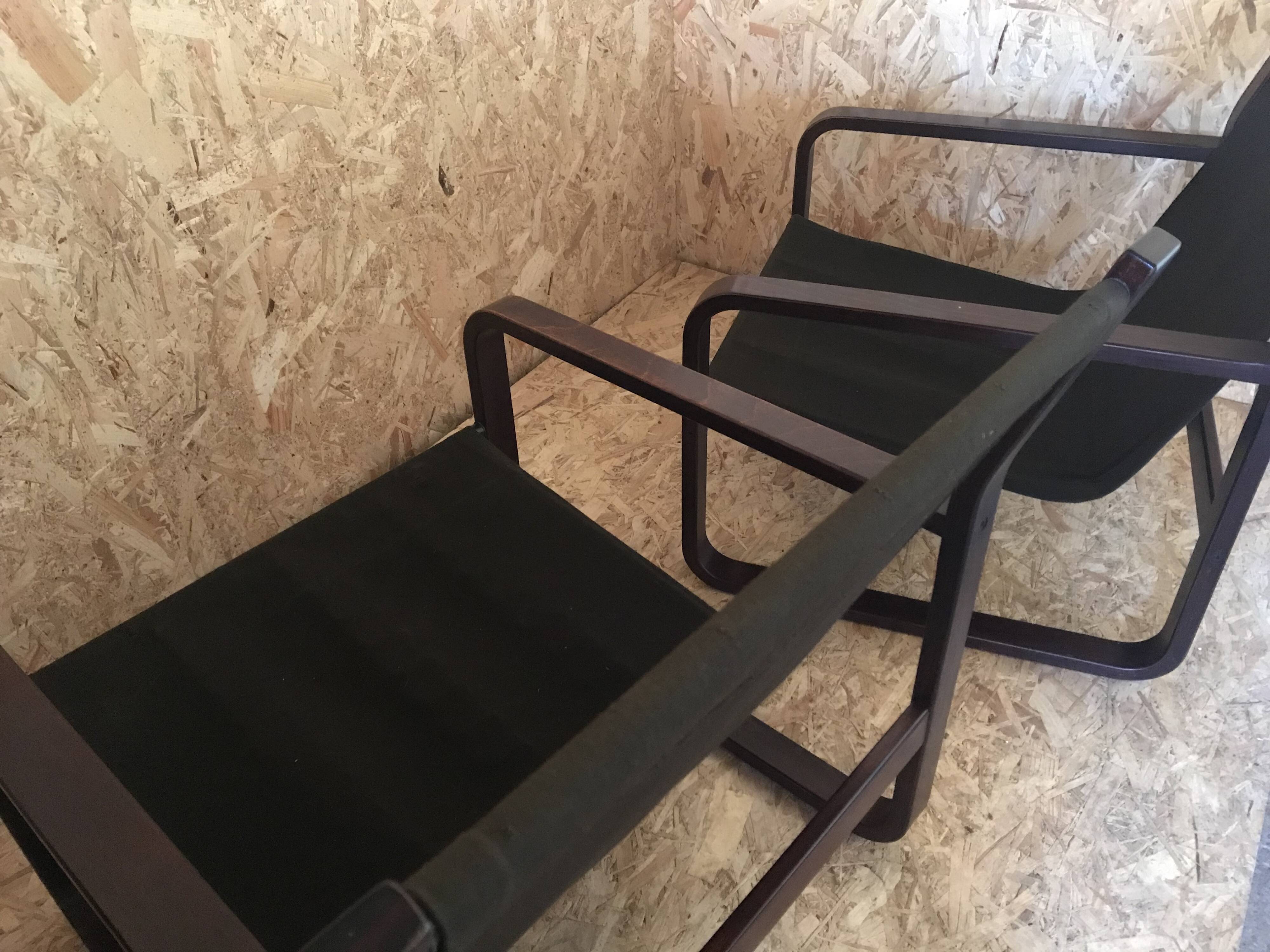 Pair of vintage armchairs in curved wood with suspended seat circa 1970-80.