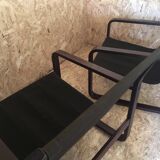 Pair of vintage armchairs in curved wood with suspended seat circa 1970-80.