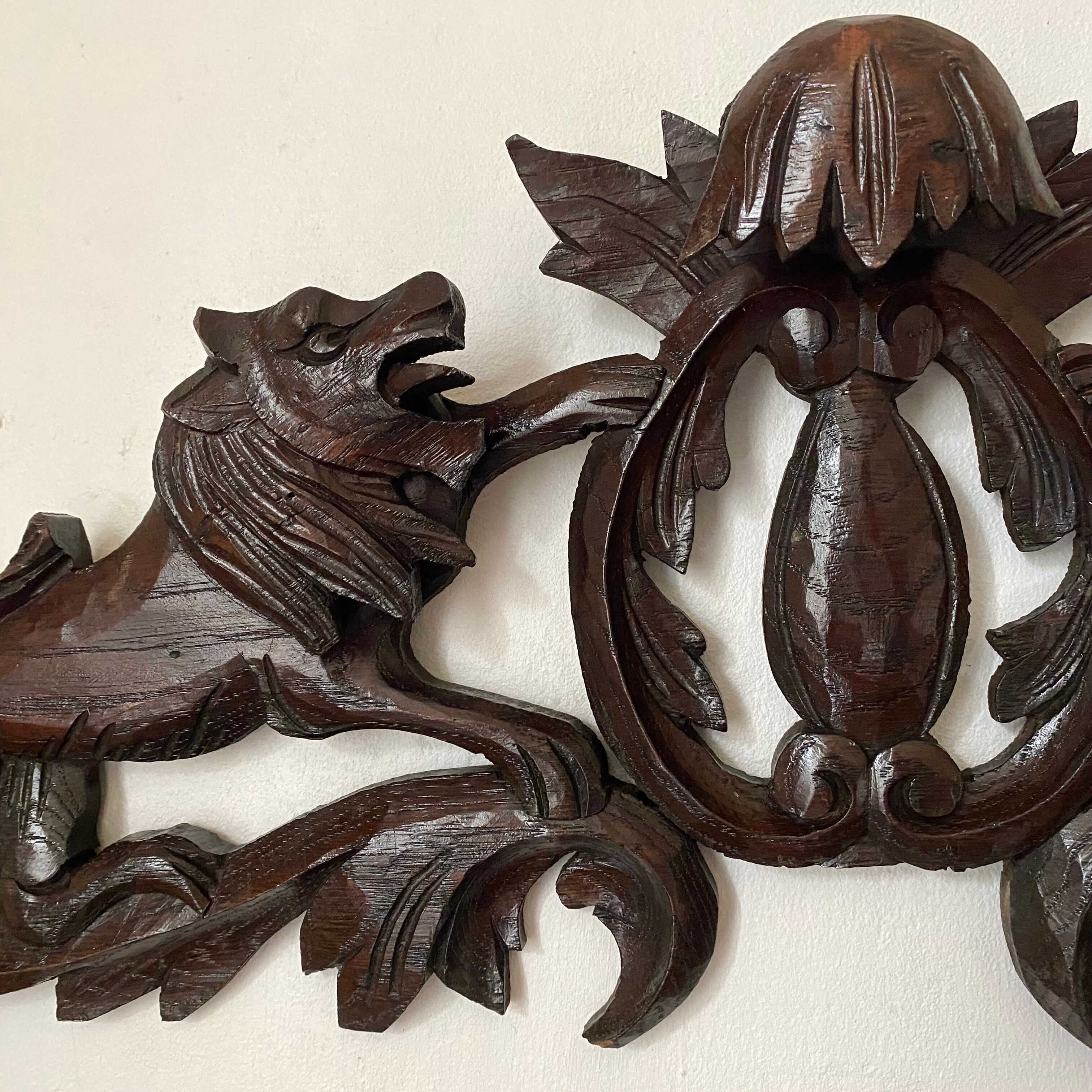 Antique carved wooden pediment with lions and medallion