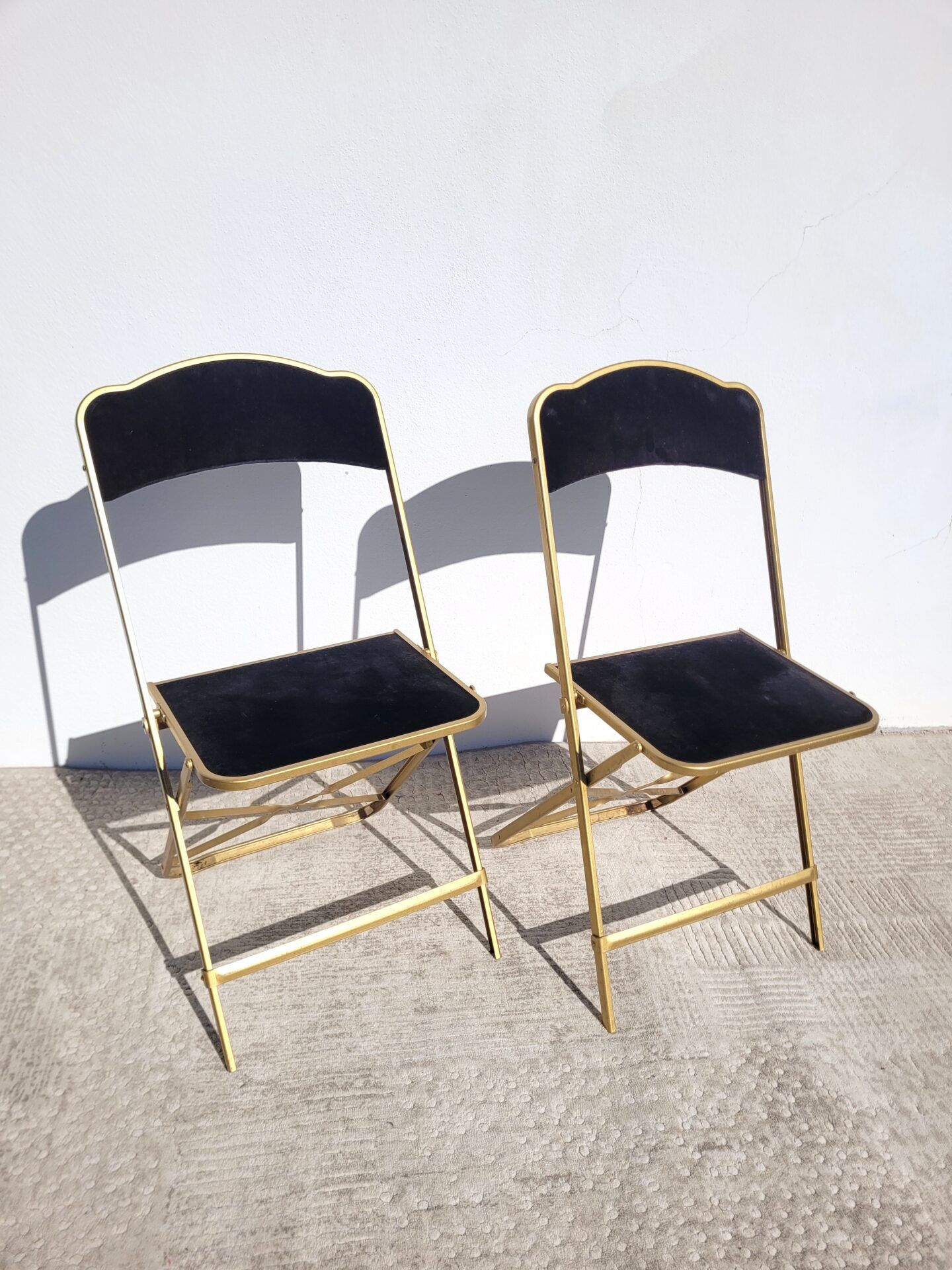 Pair of black and gold folding opera chairs