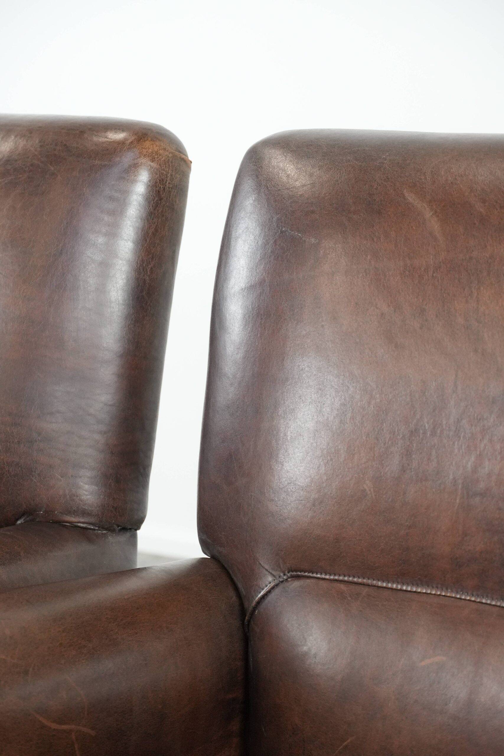 Set of two characterful sheepskin armchairs with a beautiful deep colour