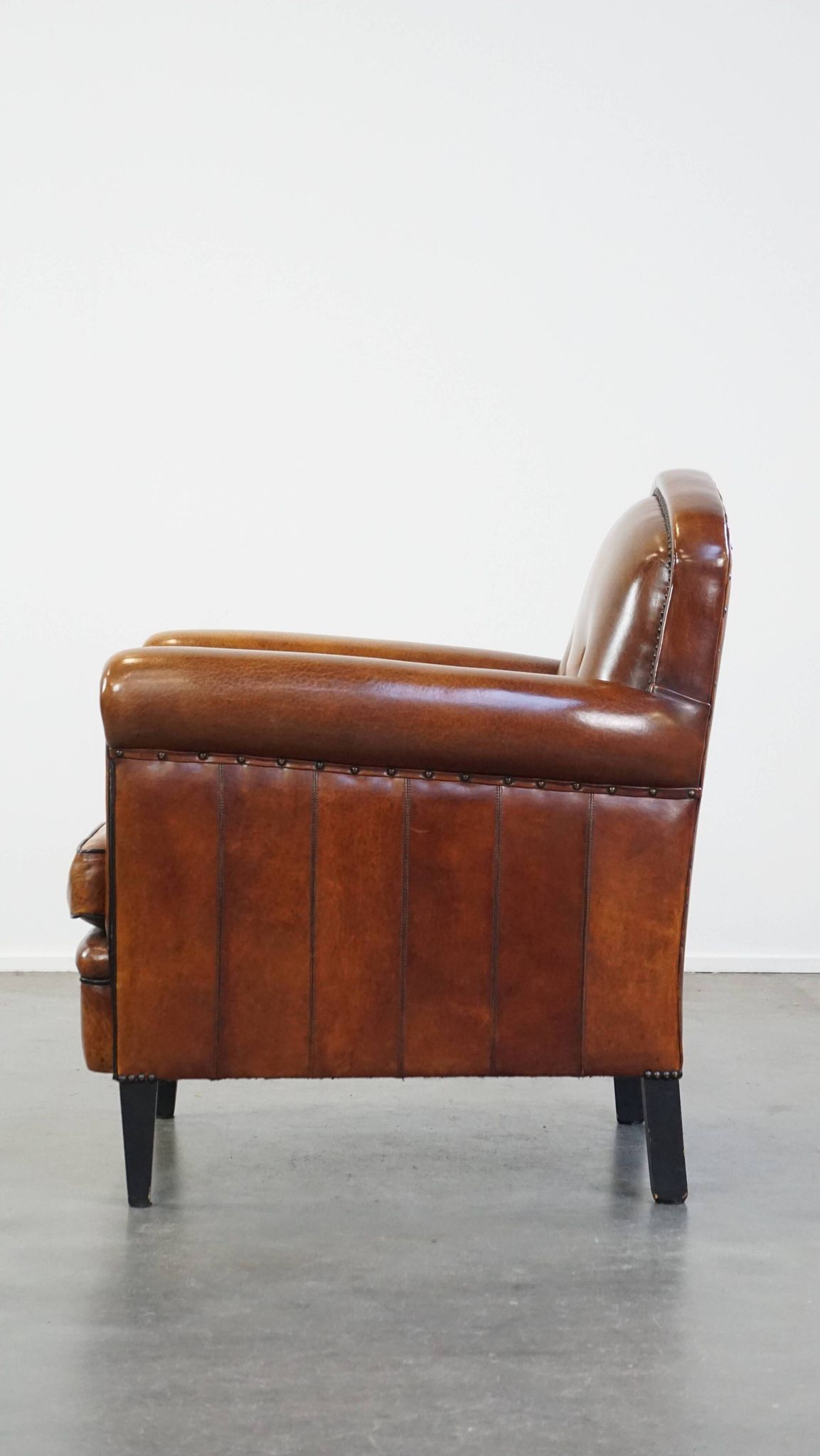 Sheep leather design armchair finished with decorative nails and black piping