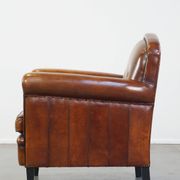 Sheep leather design armchair finished with decorative nails and black piping