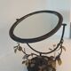 Table mirror, tilting psyche in patinated bronze decorated with leaves and fruits
