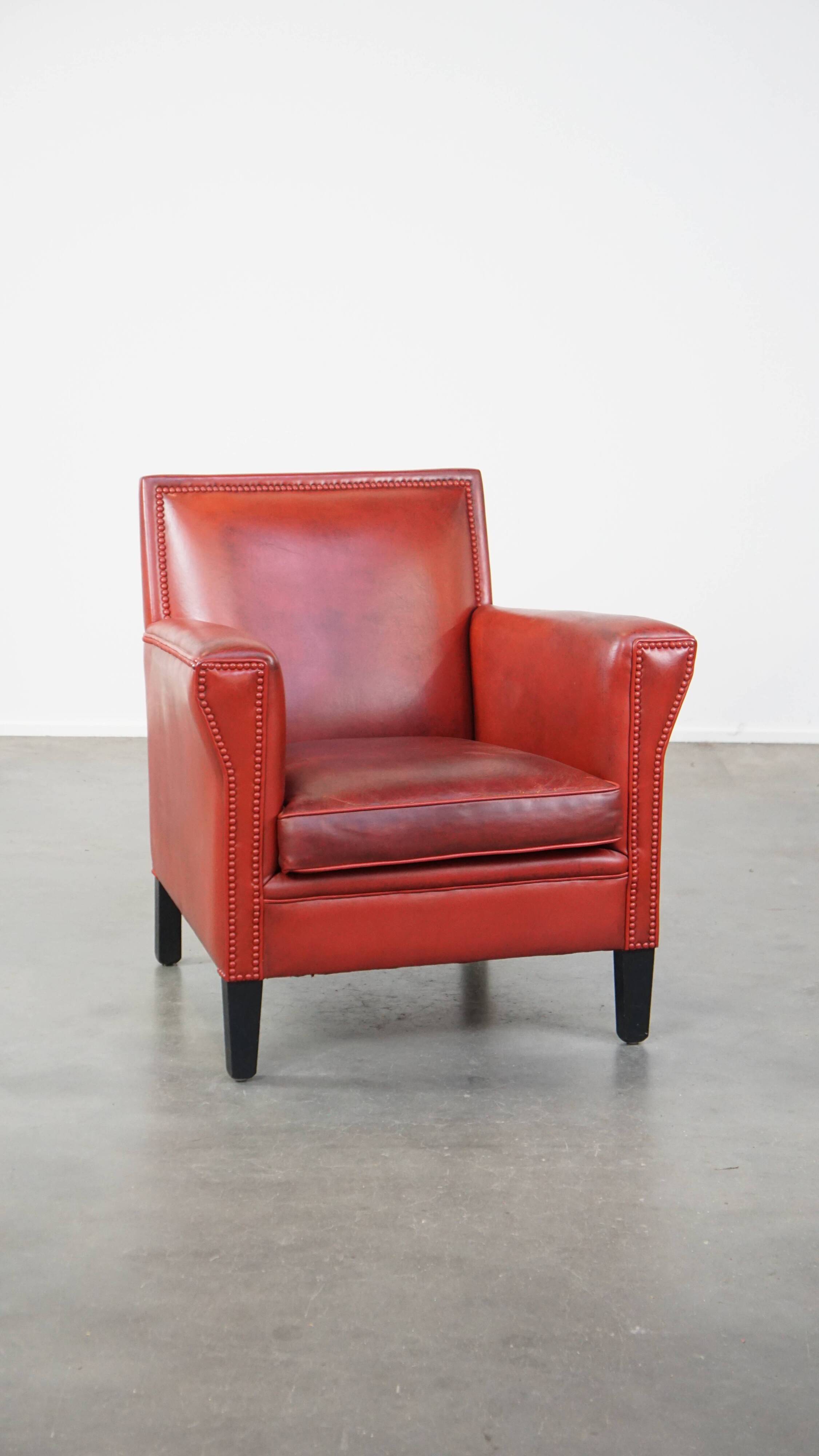 Red-painted armchair made of sheepskin leather
