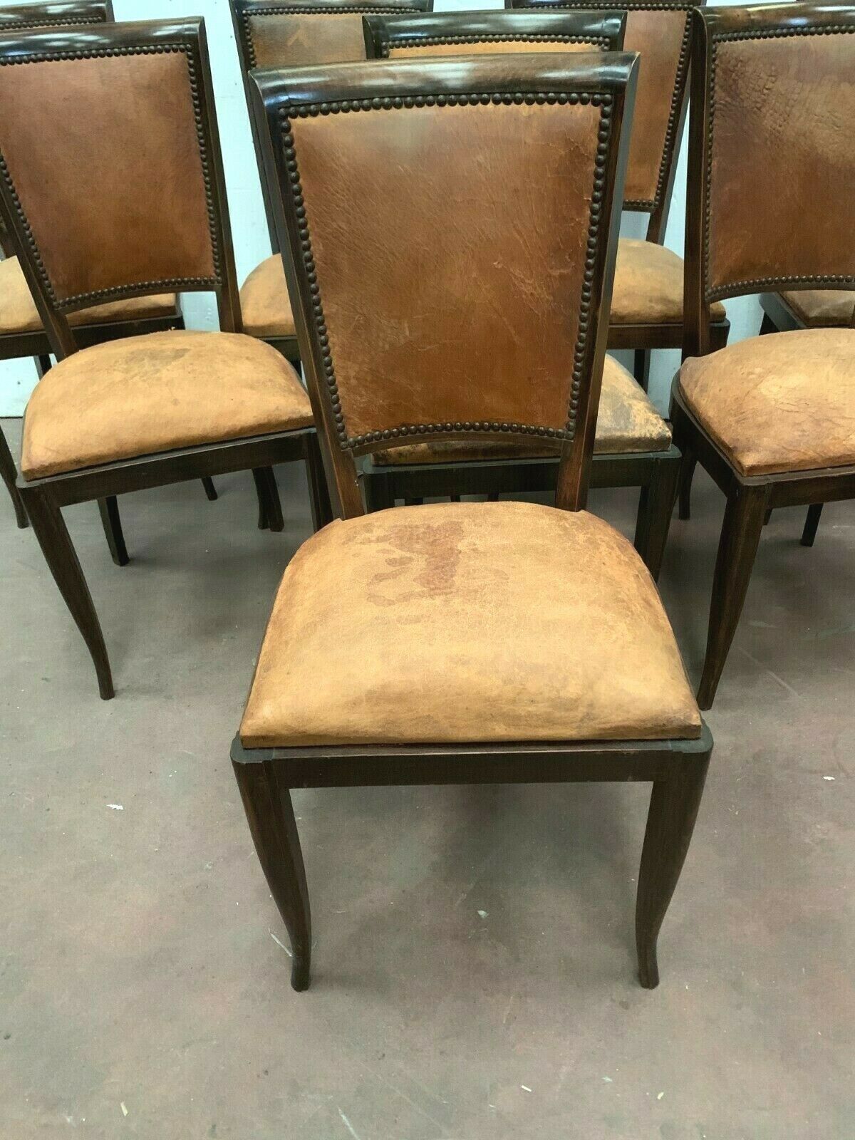 Suite of 8 seated tinted wooden chairs and tawny leather backrest 1970s