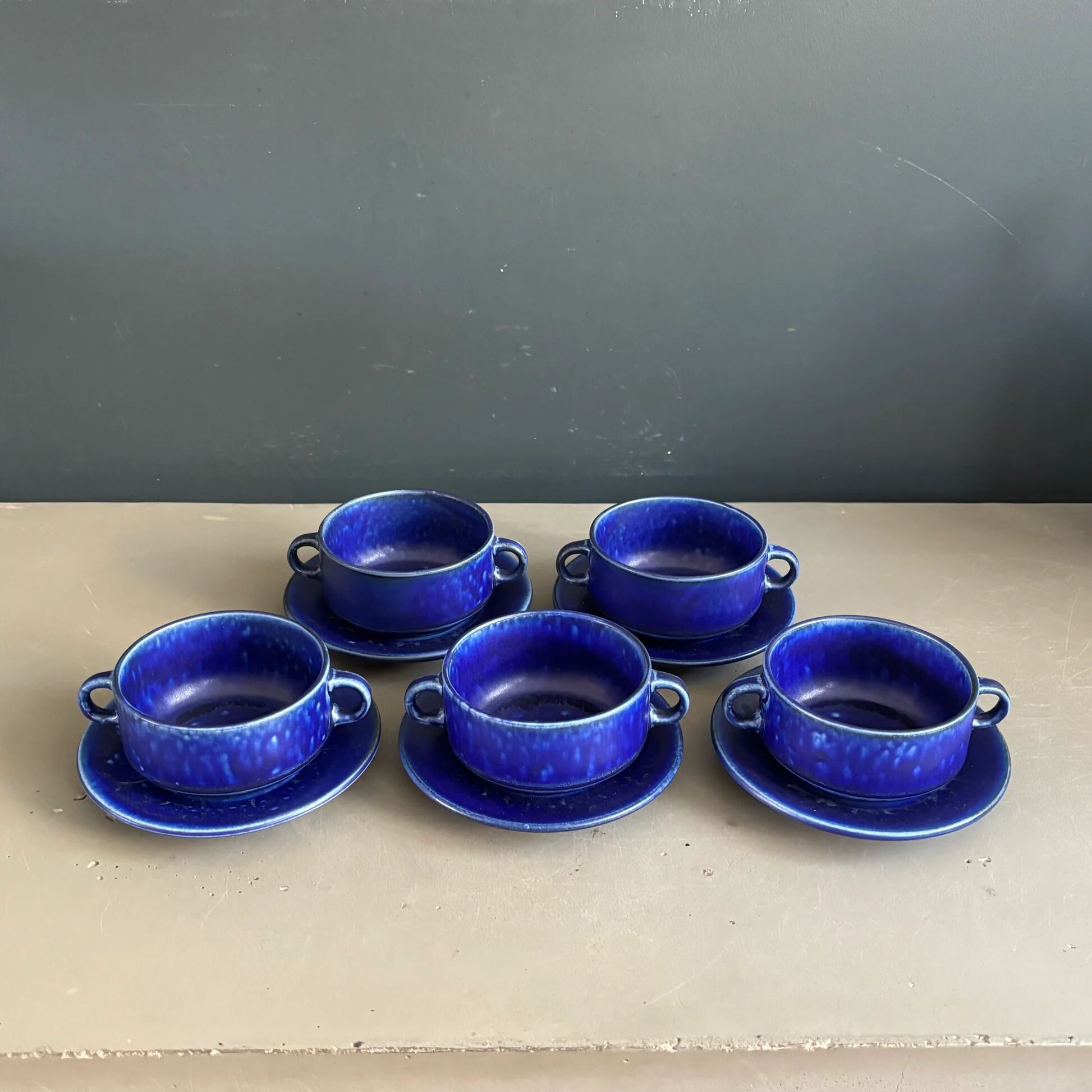 Set of 5 blue Klein ceramic tea cups with saucers.