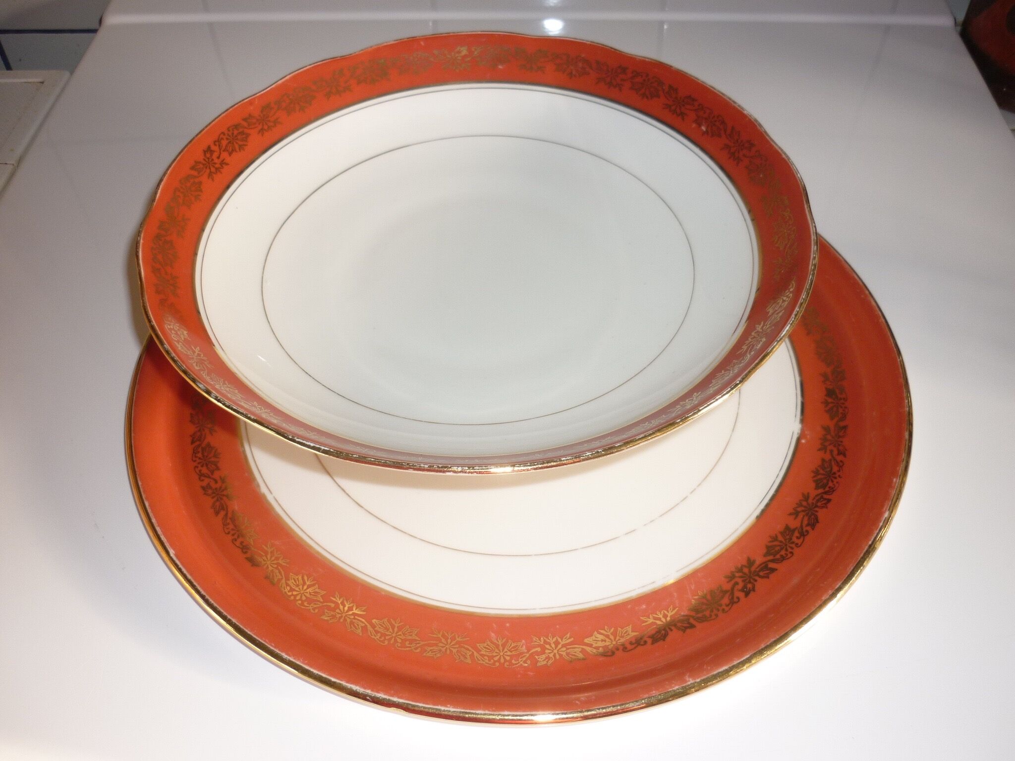 Plate and limoges porcelain dish with orange and gold trim