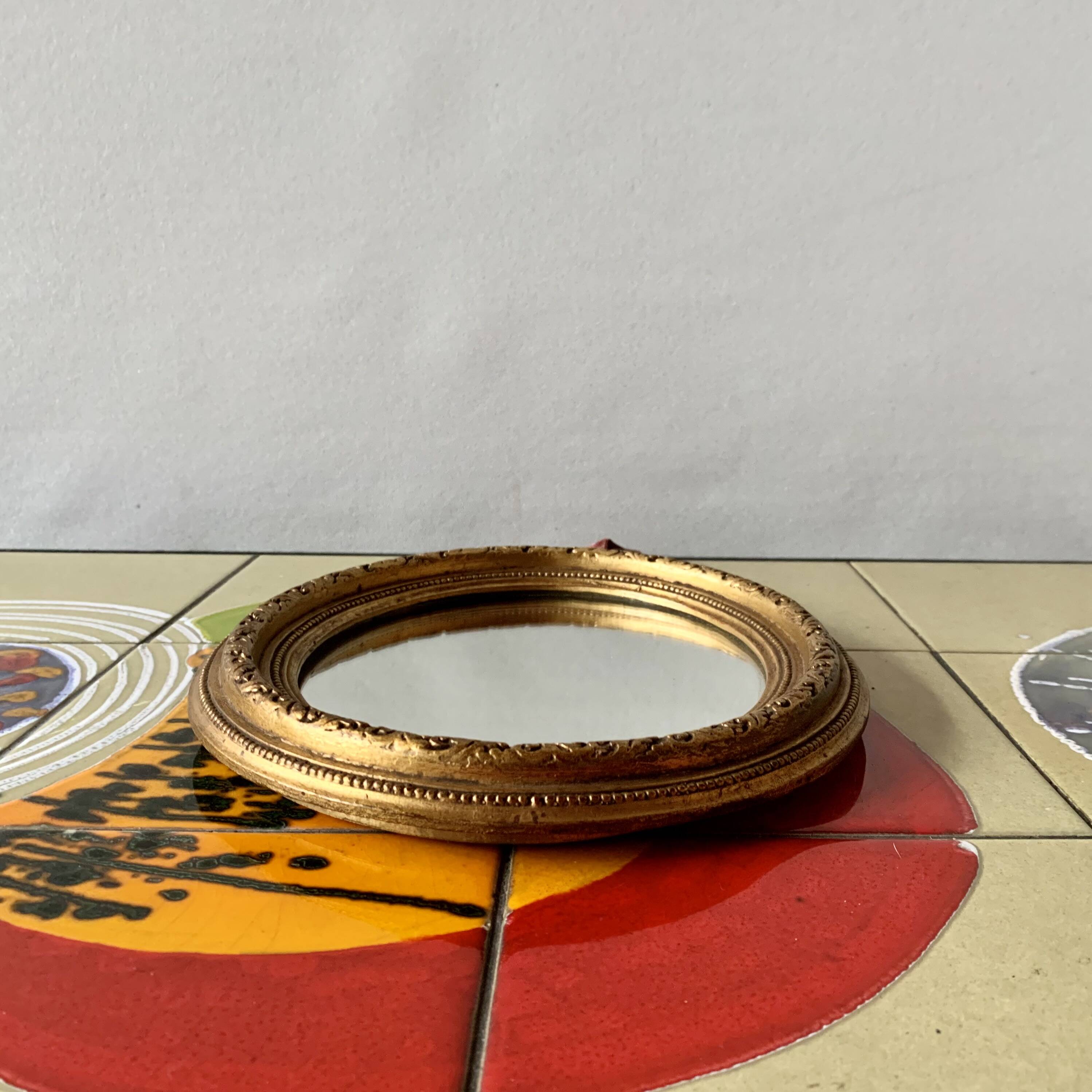 Small vintage wall mirror in gold painted wood