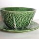 Two bowls in dabbling and their plates leaves cabbage