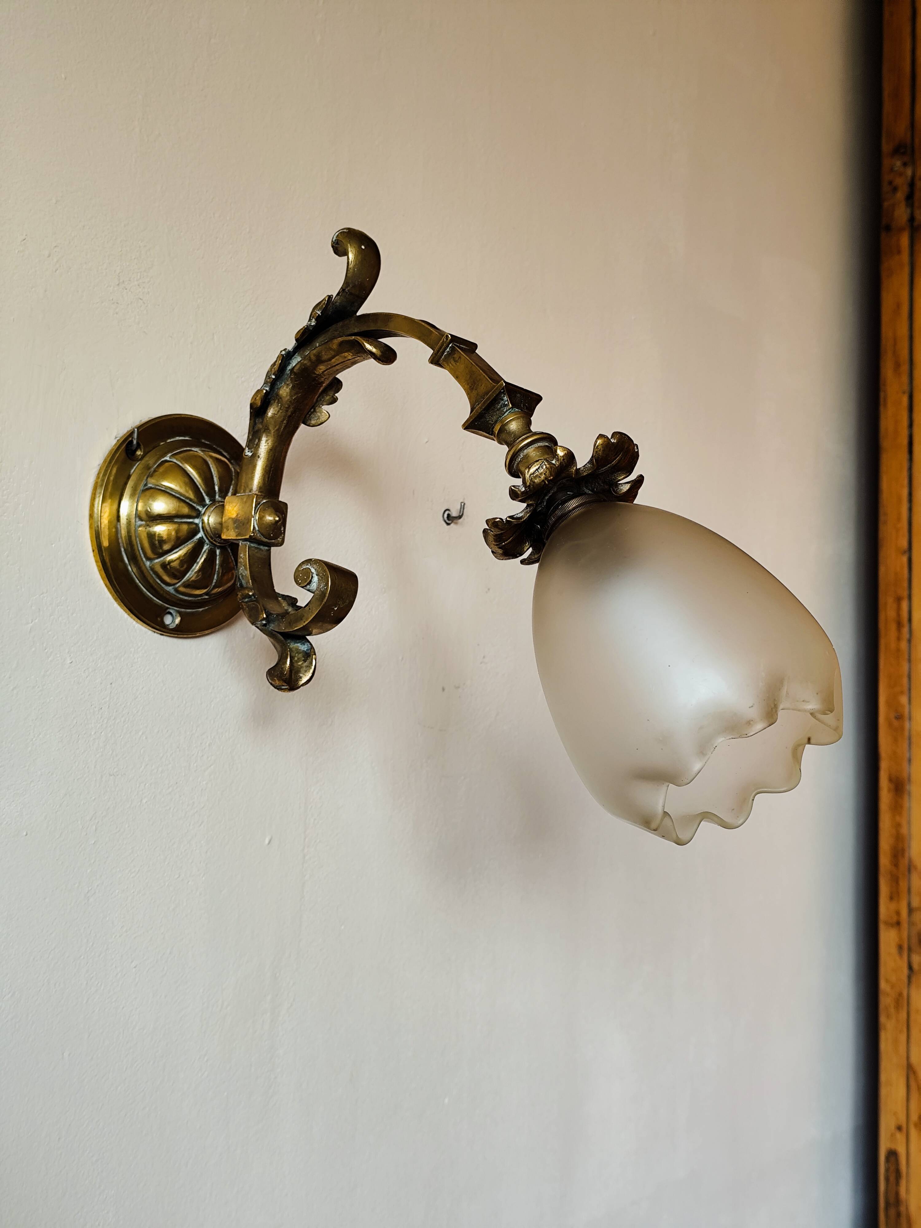 Bronze wall light with opaque glass tulip