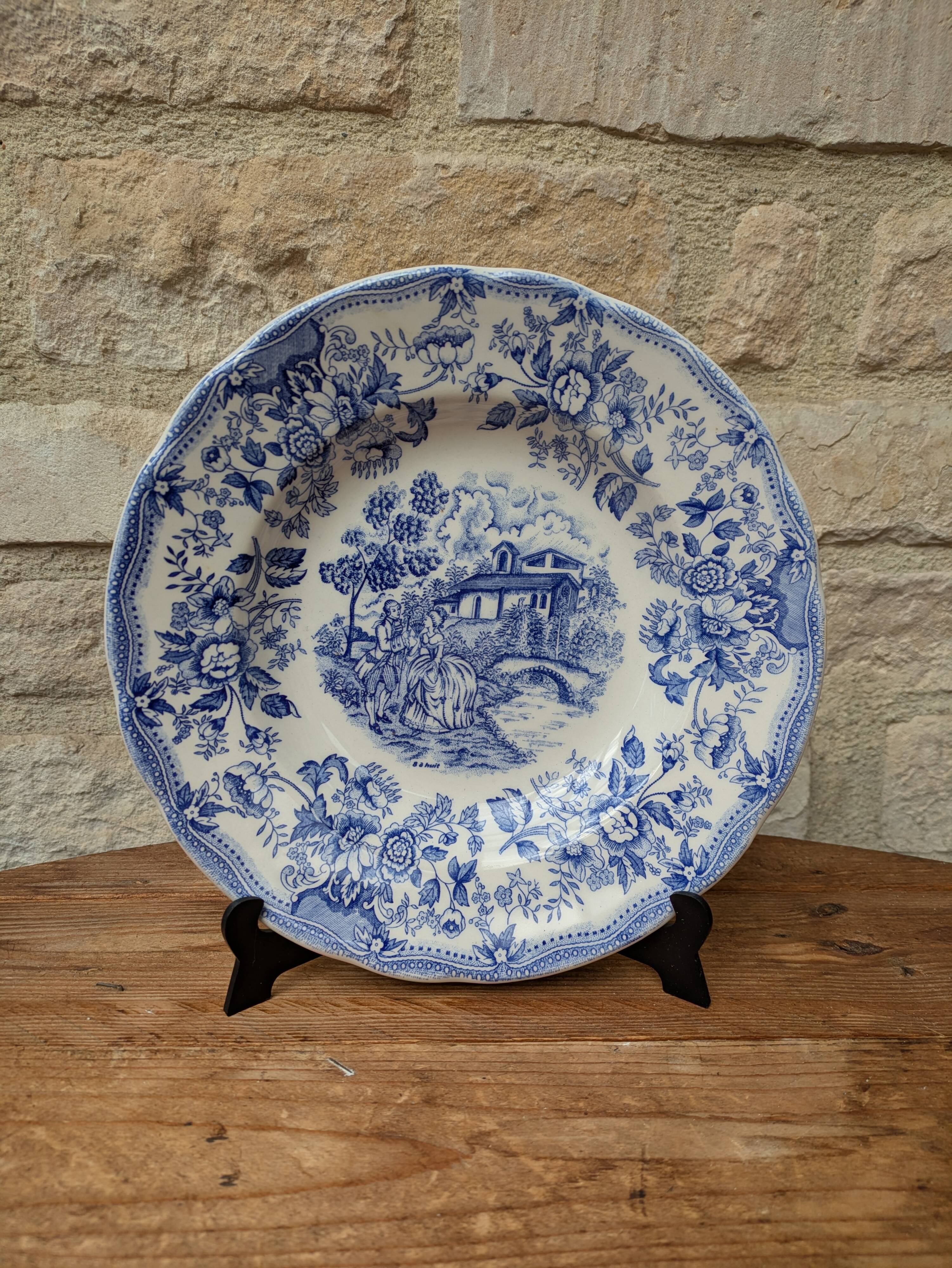 Old deep plate with blue floral pattern and gallant scene
