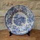 Old deep plate with blue floral pattern and gallant scene