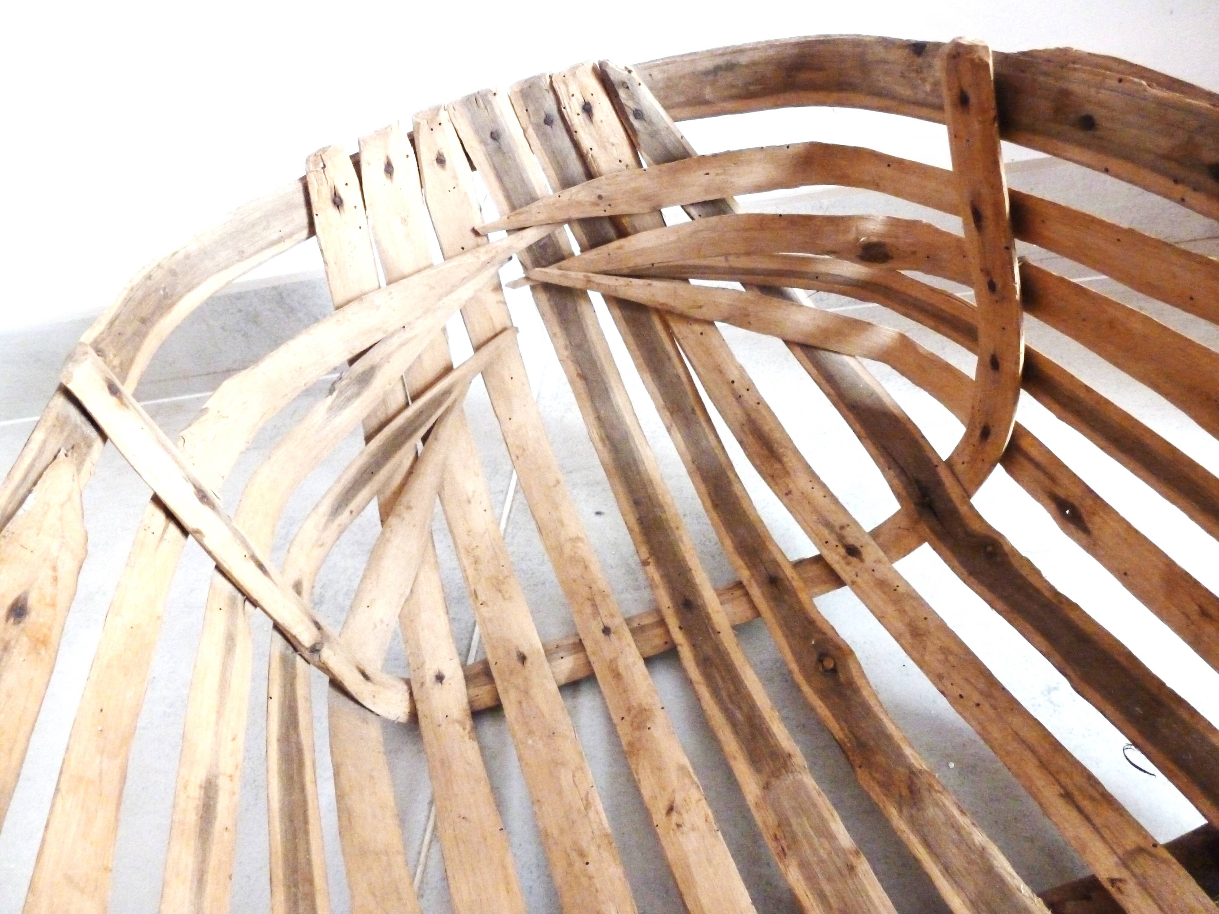 Old wooden harvest basket, slatted wooden basket, folk art.