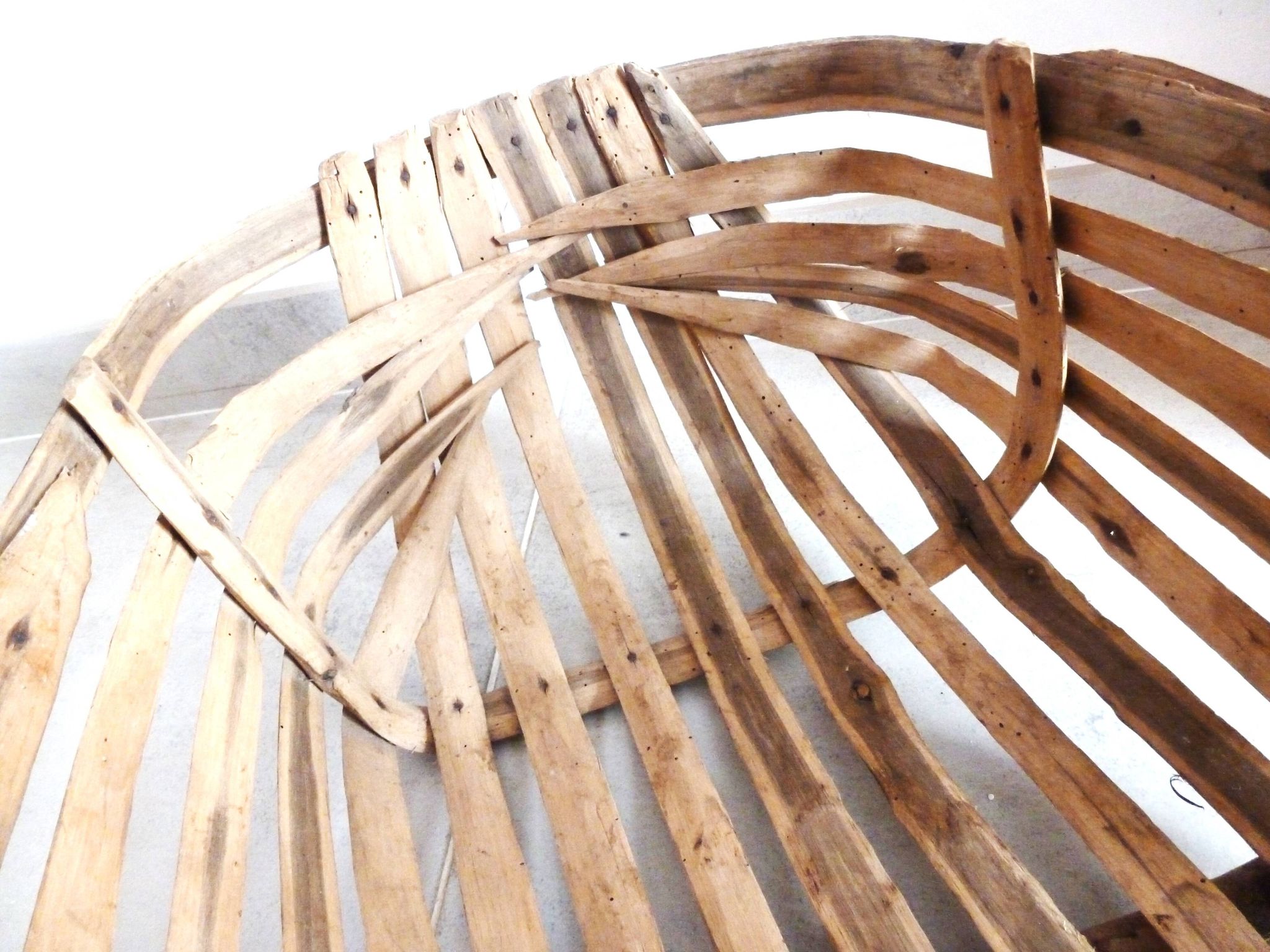 Old wooden harvest basket, slatted wooden basket, folk art.