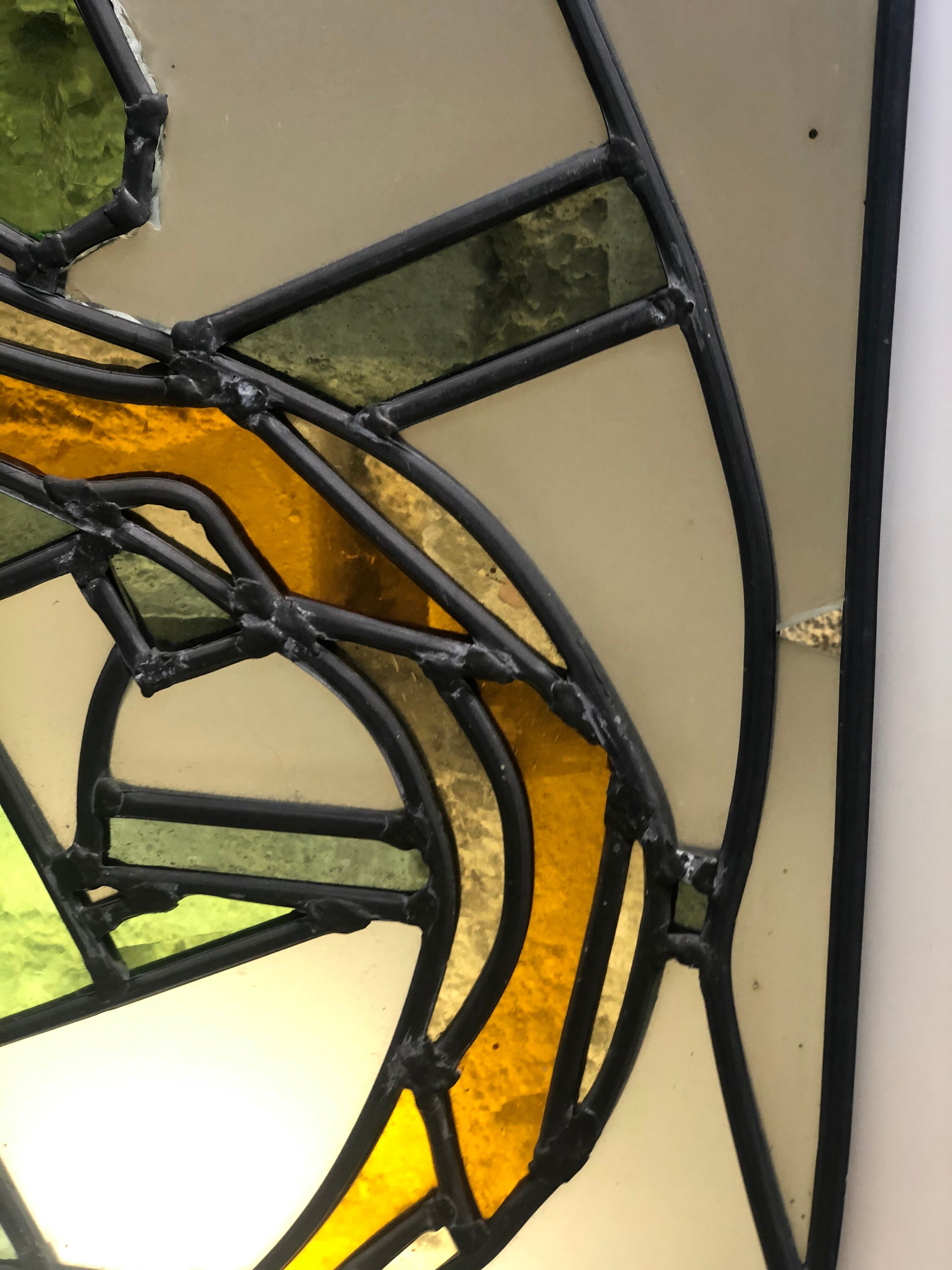 Old stained glass sign with deciduous decoration and microscope