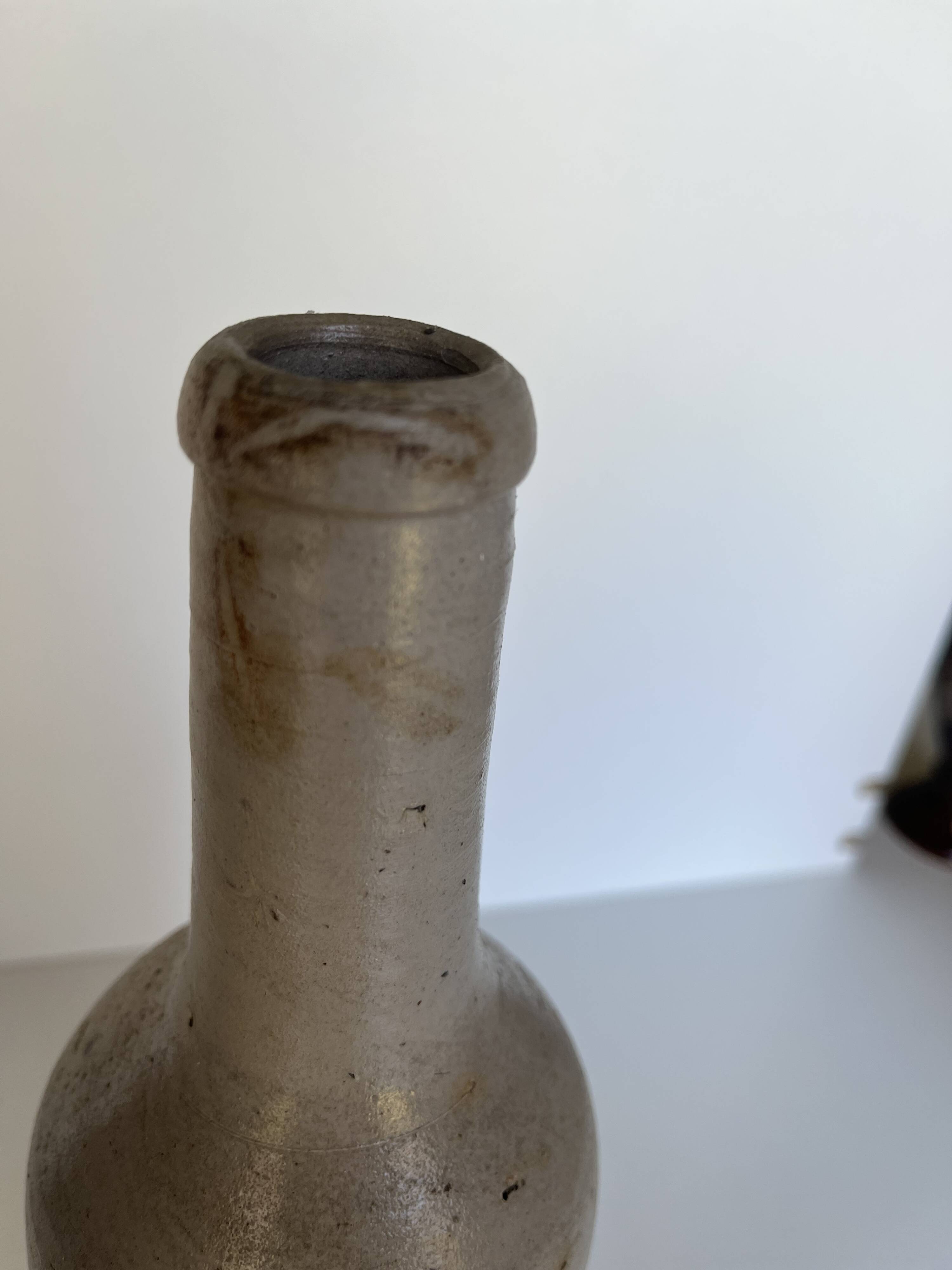 Trio of antique matte stoneware bottles