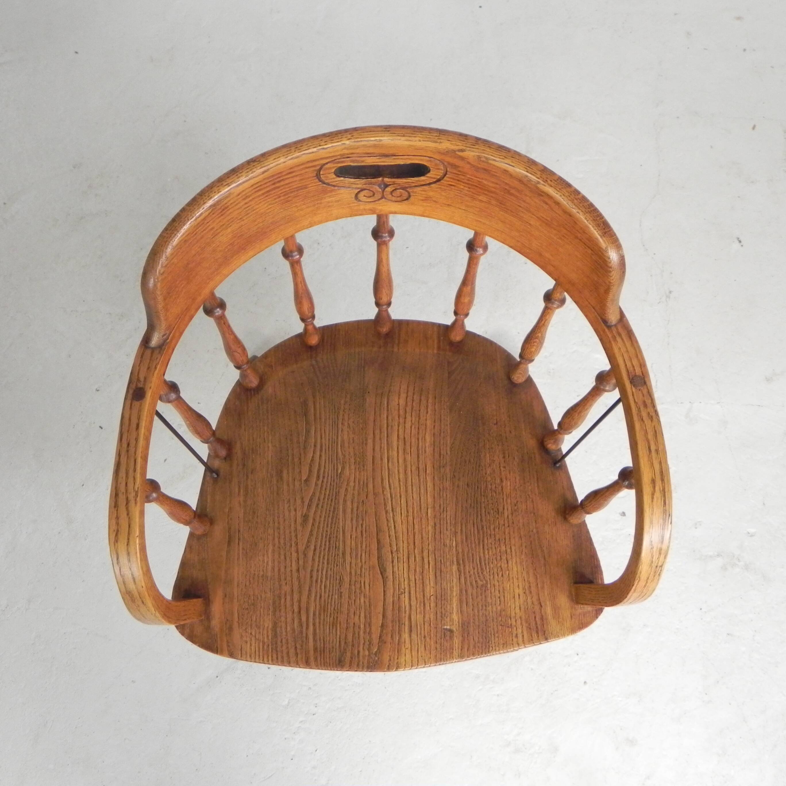 Oak office chair with a spring system and height adjustable, 1930s.