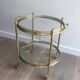 Round brass rolling table attributed to Maison Jansen
