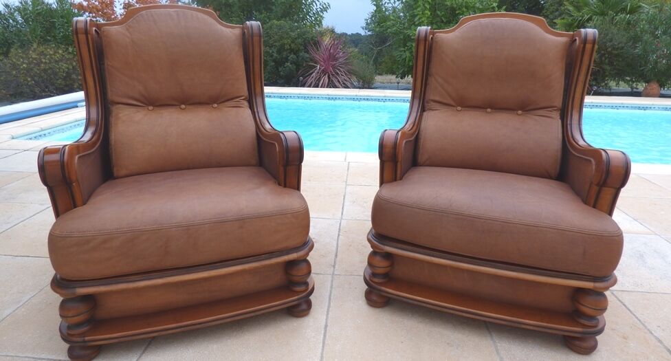 Pair of aged leather armchairs with seat and firm backrest with cherry wood frame