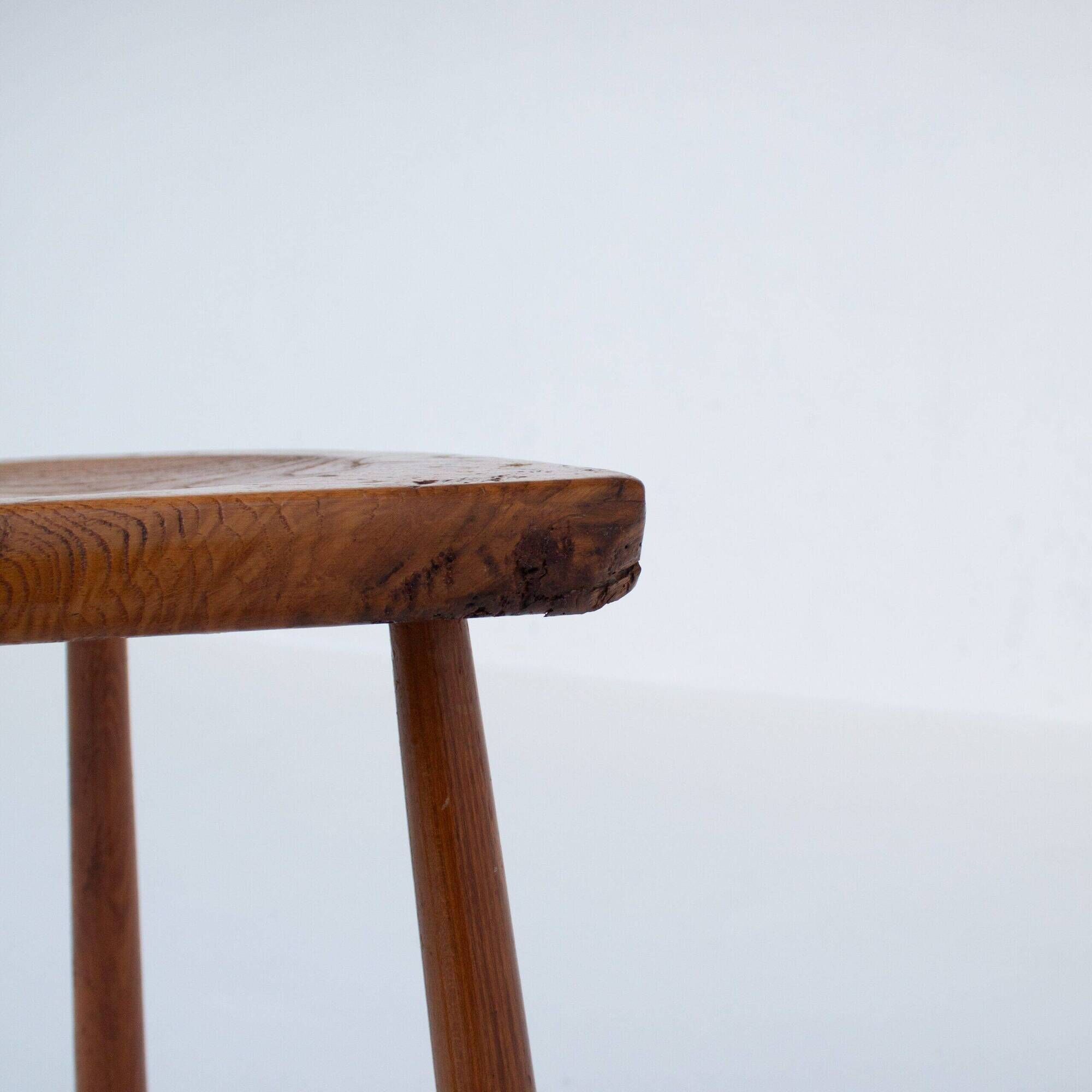Set of two hand-carved wooden stools with sculpted seats