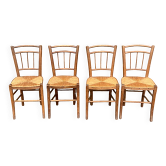 four vintage bistro-style straw chairs