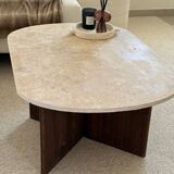 Oval coffee table in travertine and dark oak.