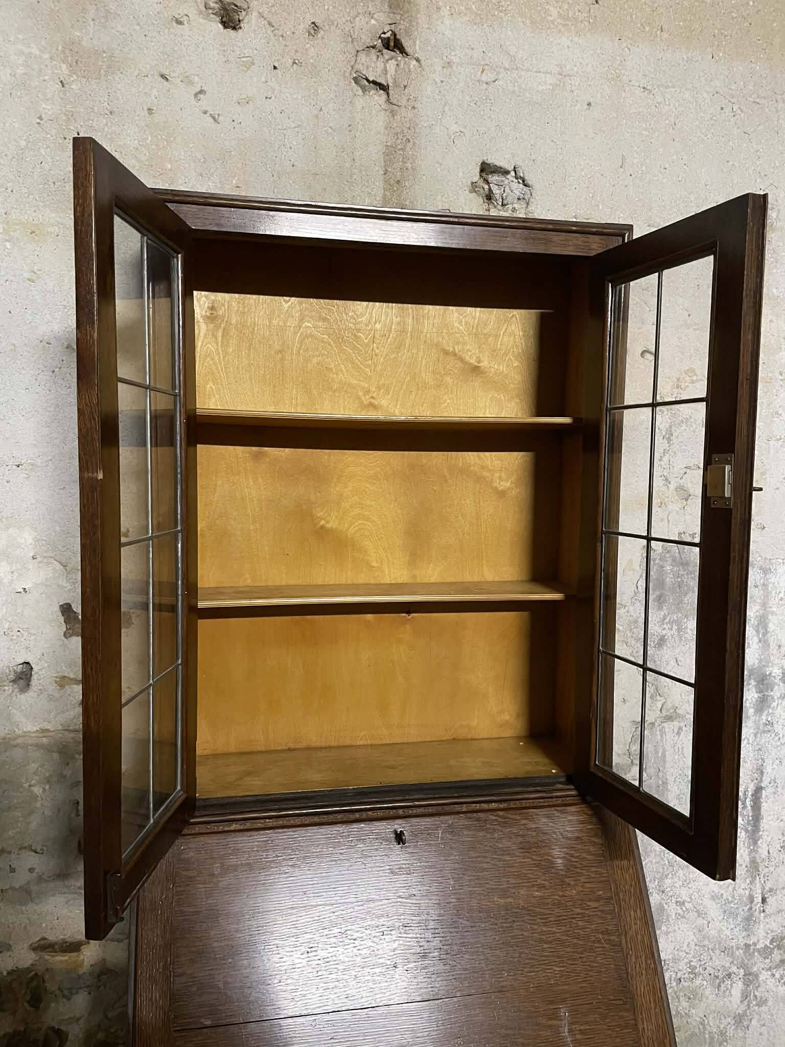 Oak display secretary cabinet with drop-down front, two sections.