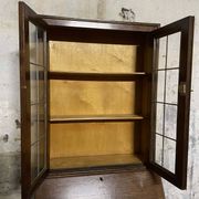 Oak display secretary cabinet with drop-down front, two sections.