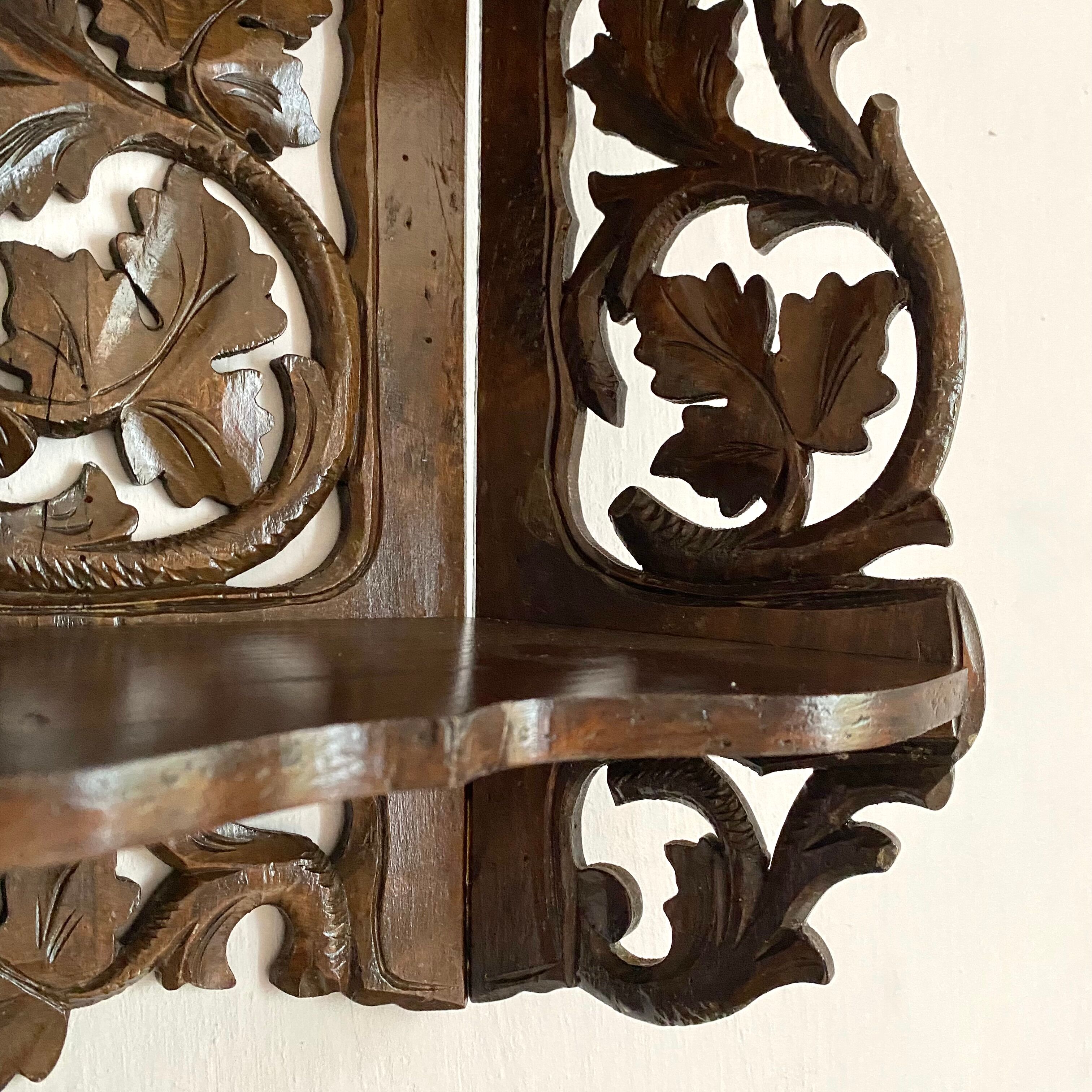 Carved wooden wall shelf