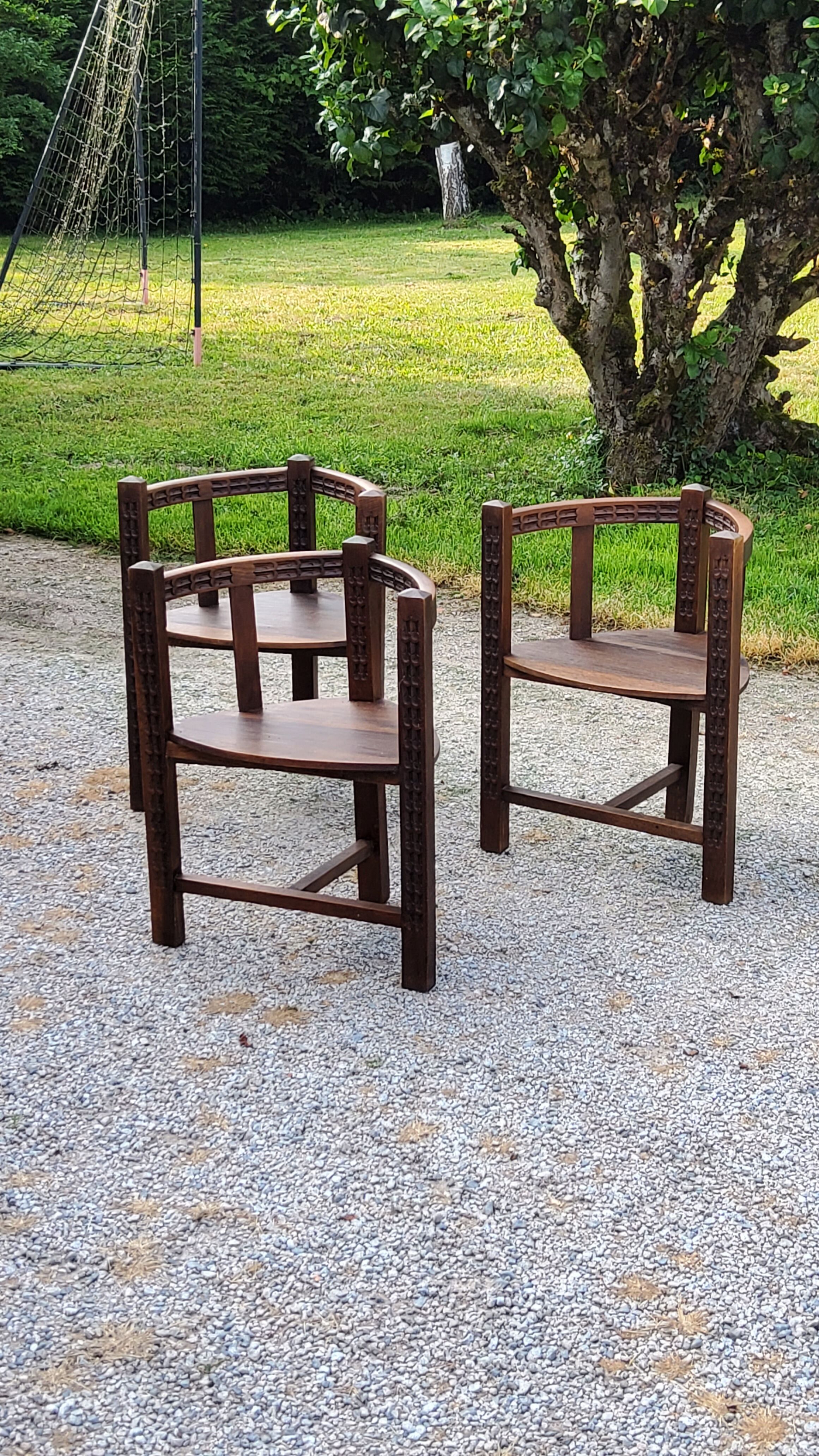 Set of three brutalist tripod armchairs in carved solid oak