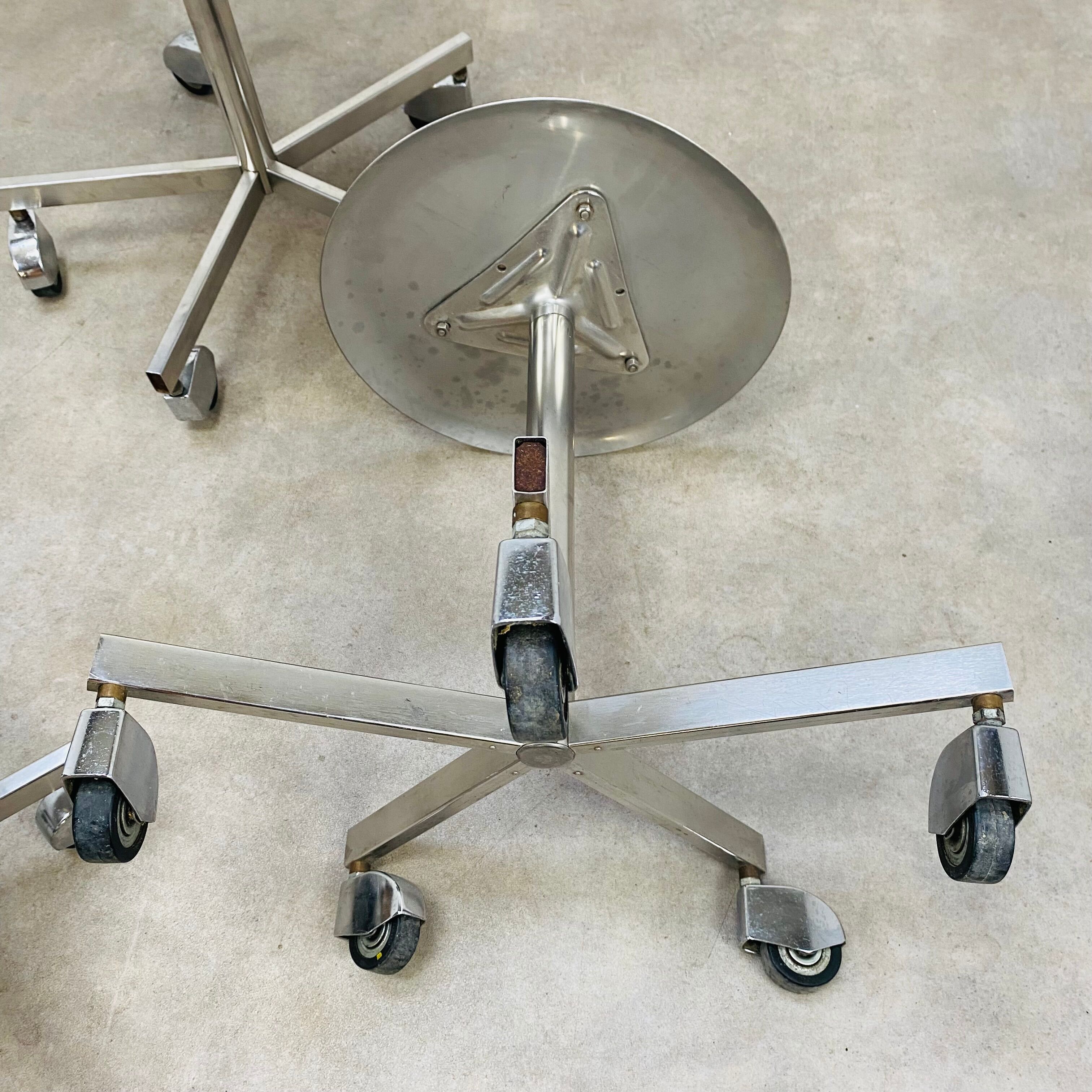 3 adjustable industrial stools with aluminum wheels