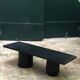 Rectangular coffee table in stained black wood with ball and cylindrical legs.