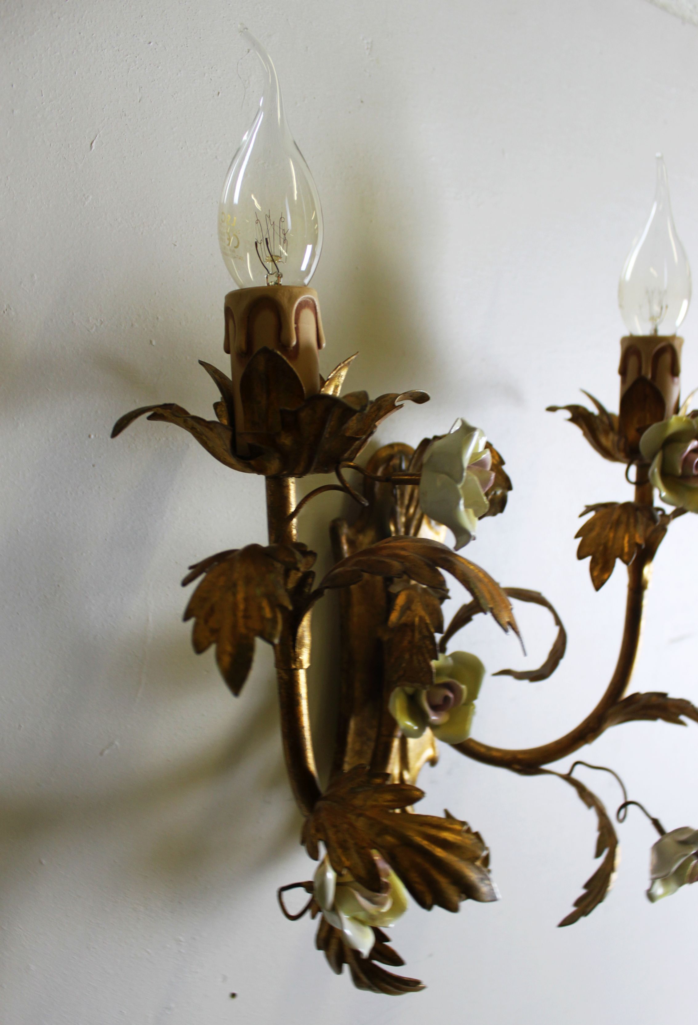 Pair of gold wall sconces with porcelain flowers