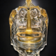 Old wall-mounted holy water font in moulded glass decorated with angels.