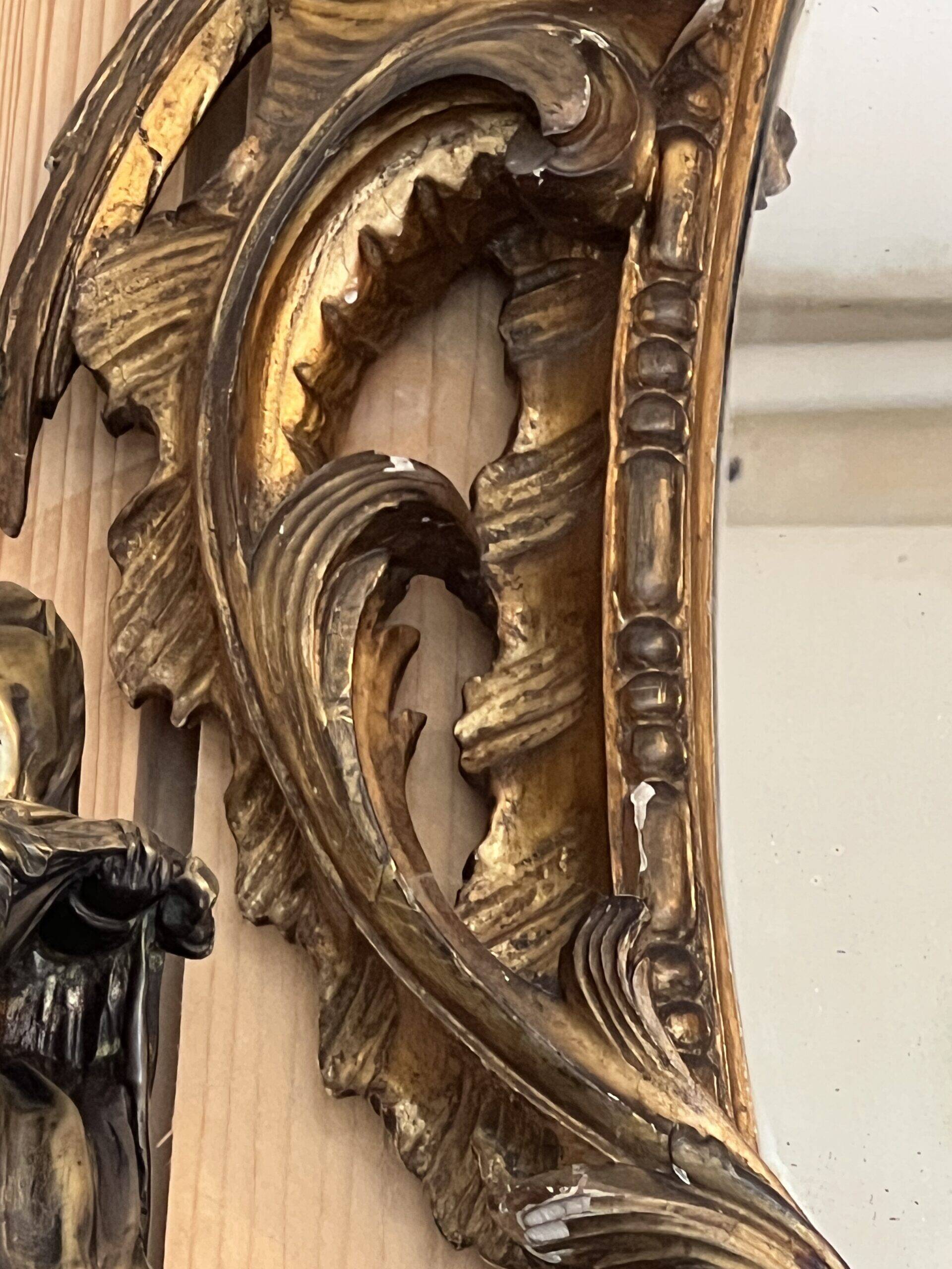 Large gilded wooden mirror, richly carved with winged dragons, 19th century