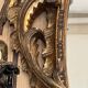 Large gilded wooden mirror, richly carved with winged dragons, 19th century