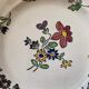 7 hand-painted flowered dinner plates.