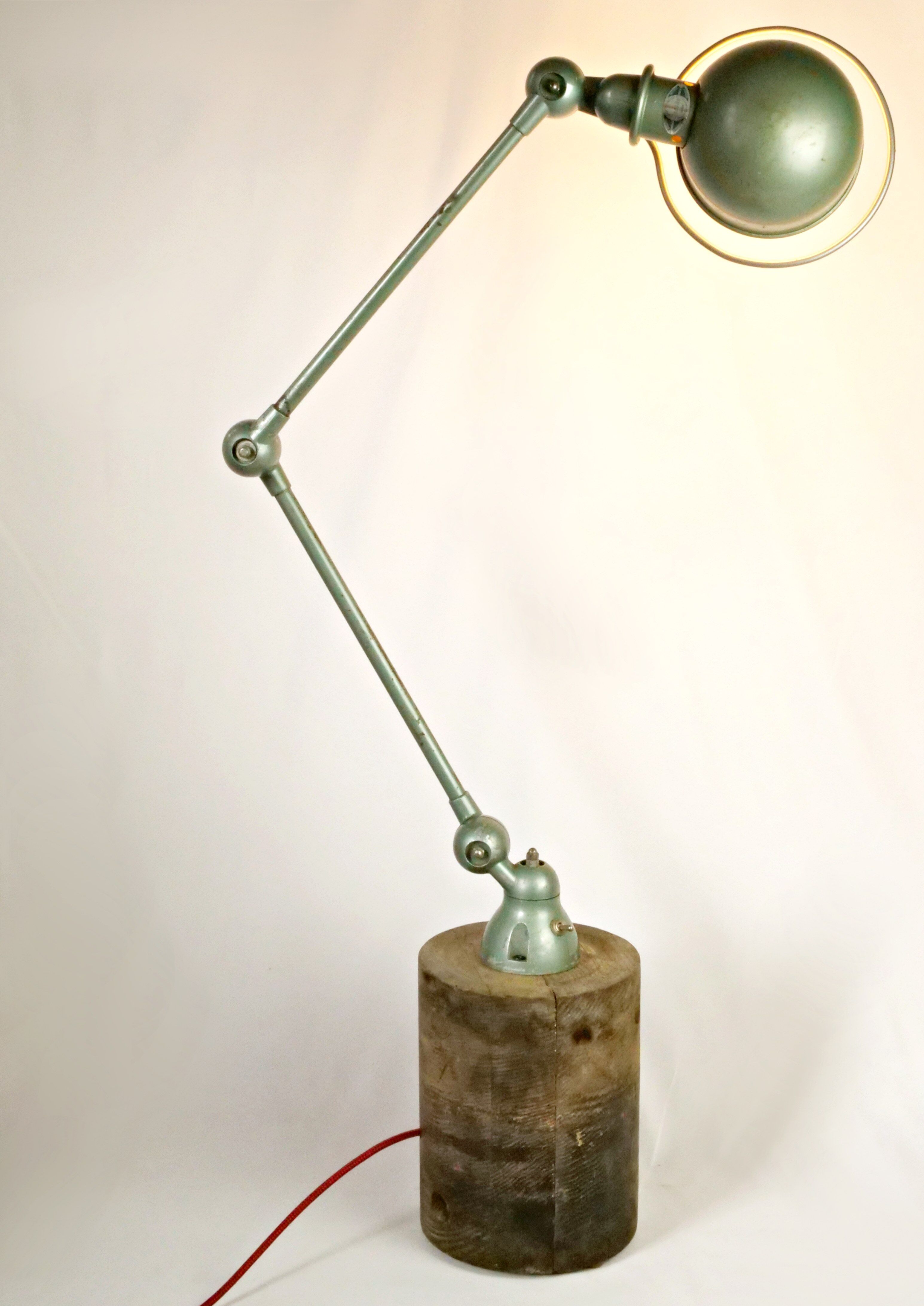 Jielde table lamp with 2 arms on a wooden base.