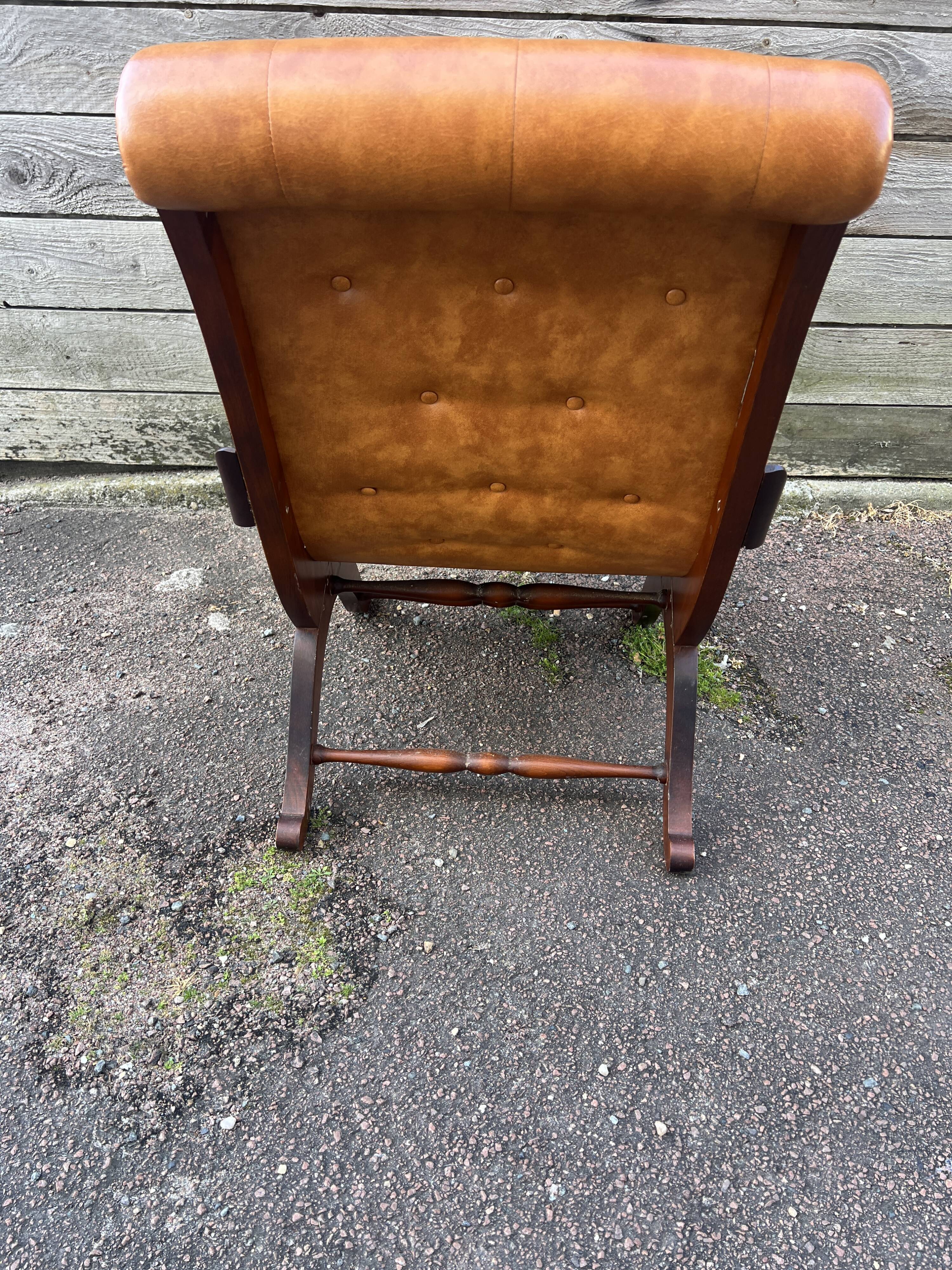 Chesterfield leather slipper chair with mahogany