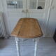 Oval table with beaded grey patinated flaps, wooden tray