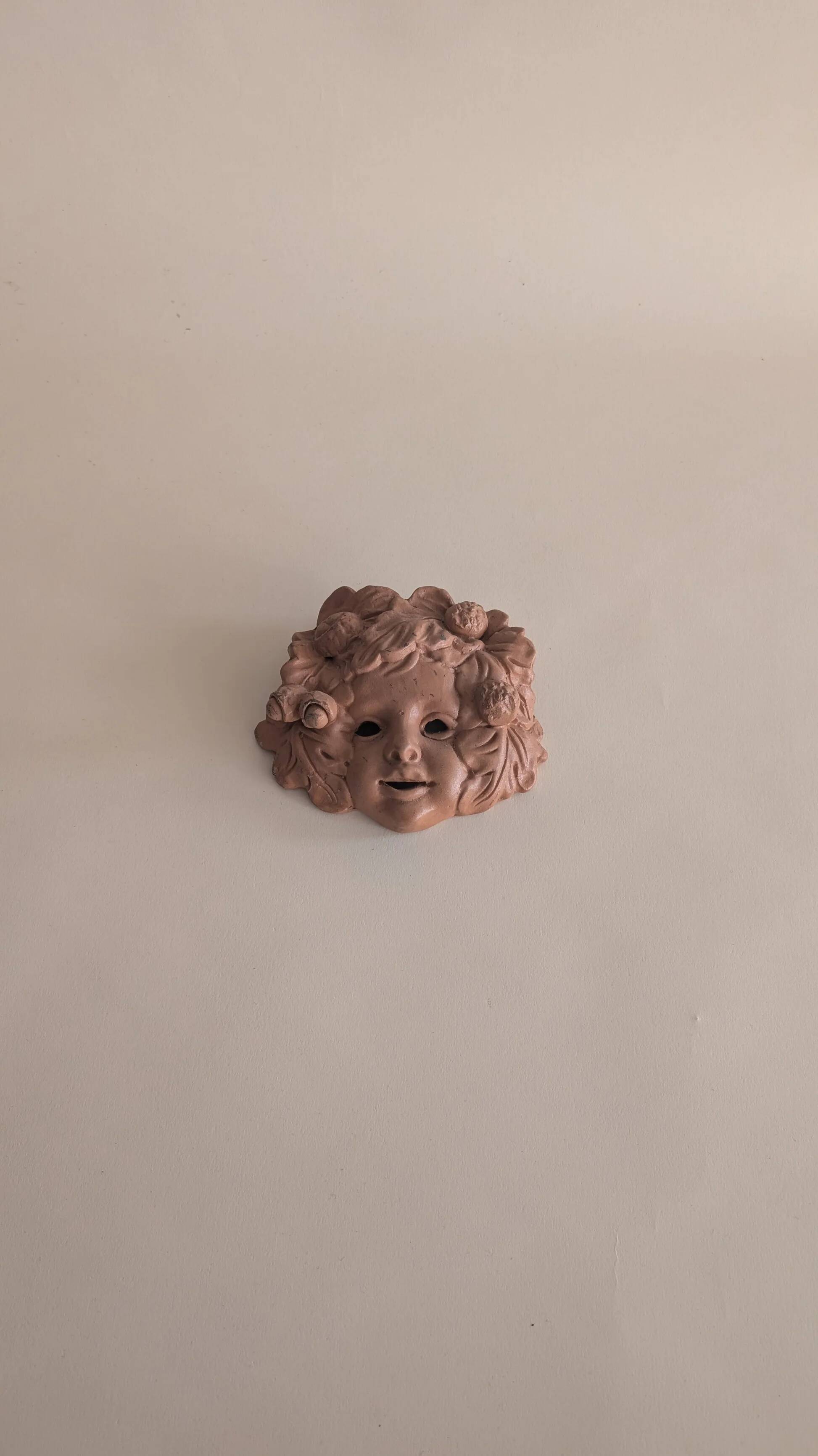 Vintage terracotta wall mask - flowery child's face