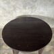 Antique round coffee table in Indonesian teak with turned legs.