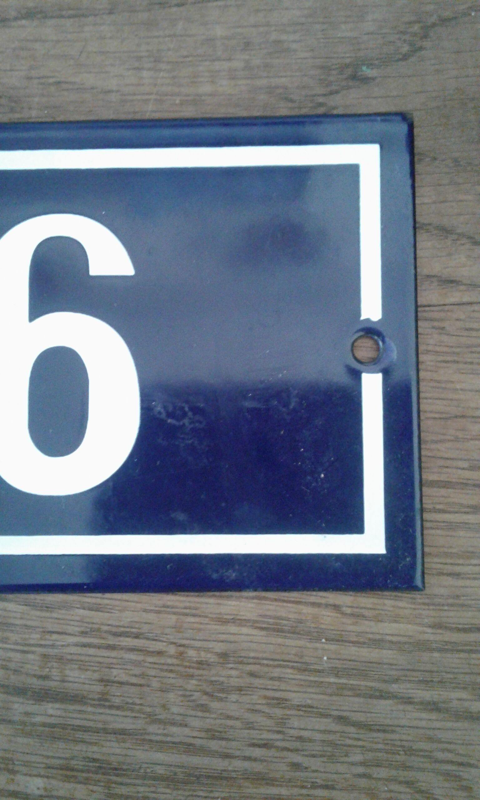 Enamelled street sign bears the number 6