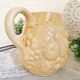 Vintage yellow pitcher in fruit slip