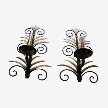 Wrought iron sconces decorated with golden pineapple leaves